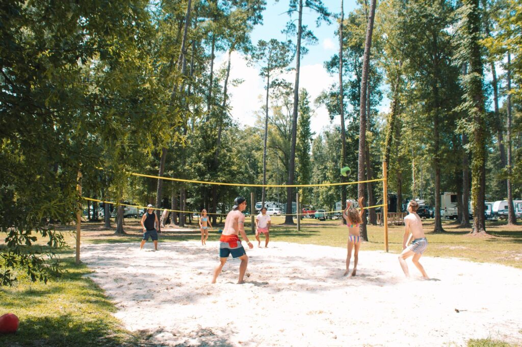 Guests playing beach volleyball at Fireside RV Resort in Ponchatoula, Louisiana.