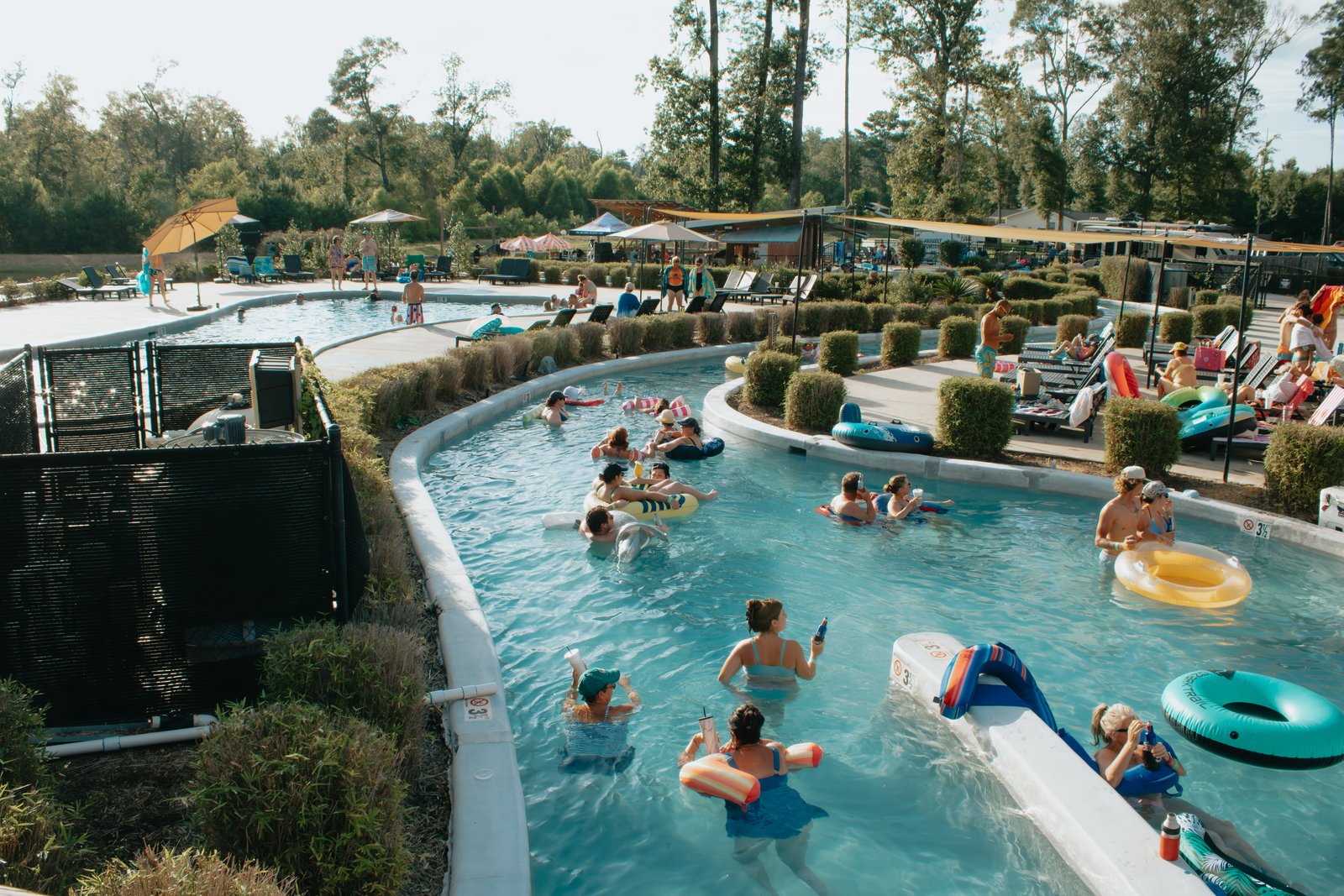 Guests floating the lazy river at Fireside RV Resort on a sunny day