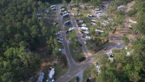 Aerial view of full-hookup RV sites among pines at a Louisiana Northshore RV resort
