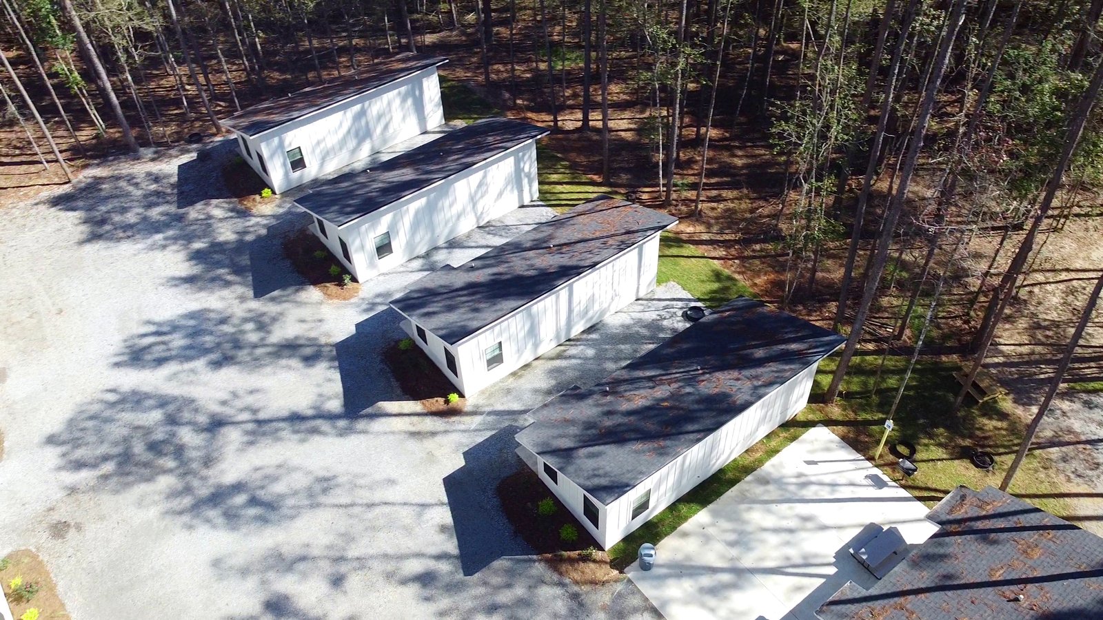 Furnished cabins nestled among tall pine trees at Fireside RV Resort in Ponchatoula, Louisiana