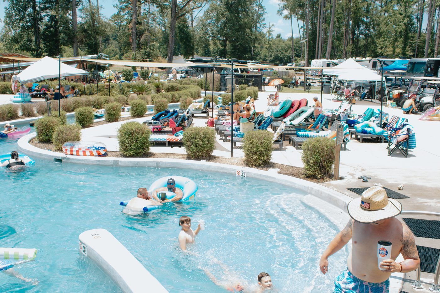 Guests floating the lazy river at Fireside RV Resort on a sunny day