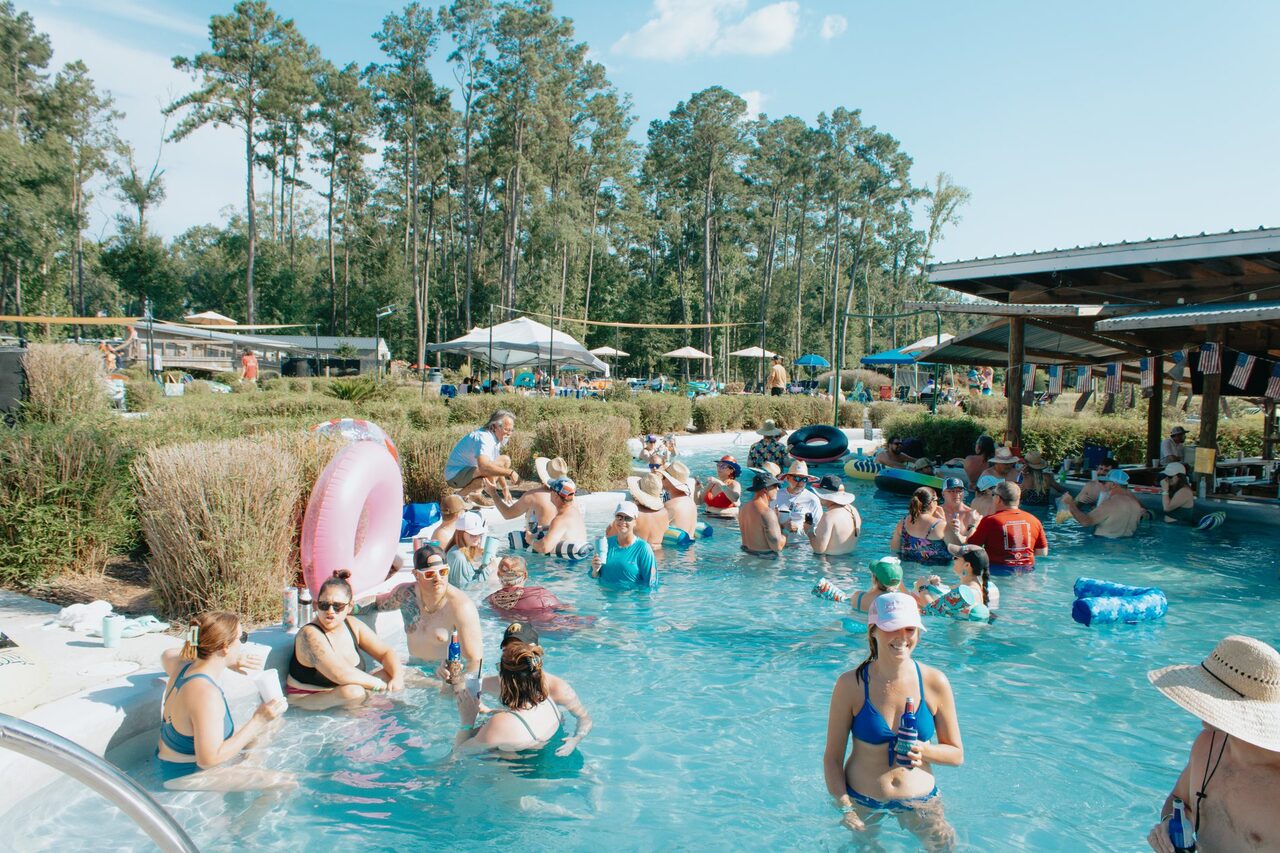 Families swimming and floating the lazy river pool at Fireside RV Resort