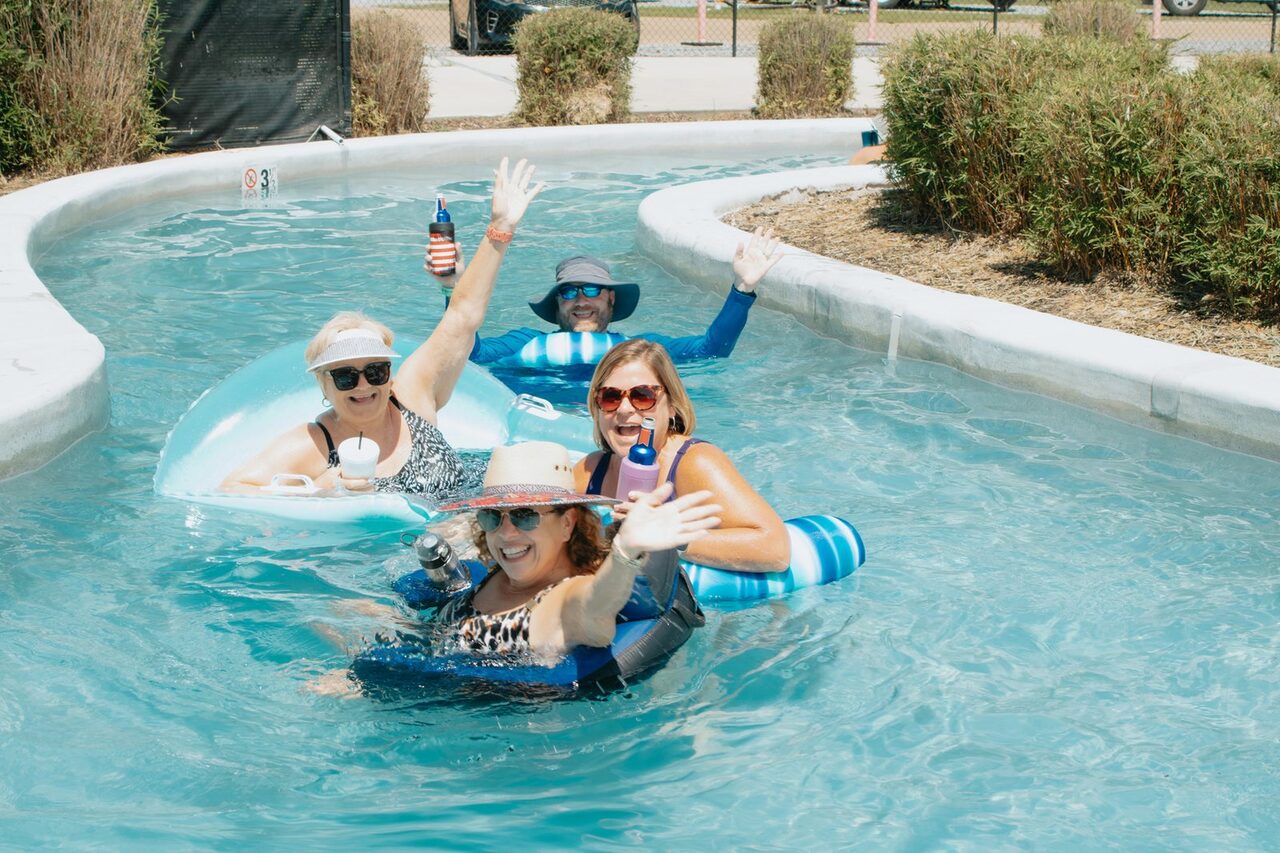 Four guests floating on tubes in the Fireside lazy river