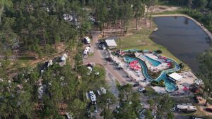 Aerial view of Fireside RV Resort with lazy river, pools, and shaded RV sites near Mandeville