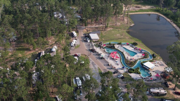 Aerial view of Fireside RV Resort with lazy river, pools, and shaded RV sites near Mandeville