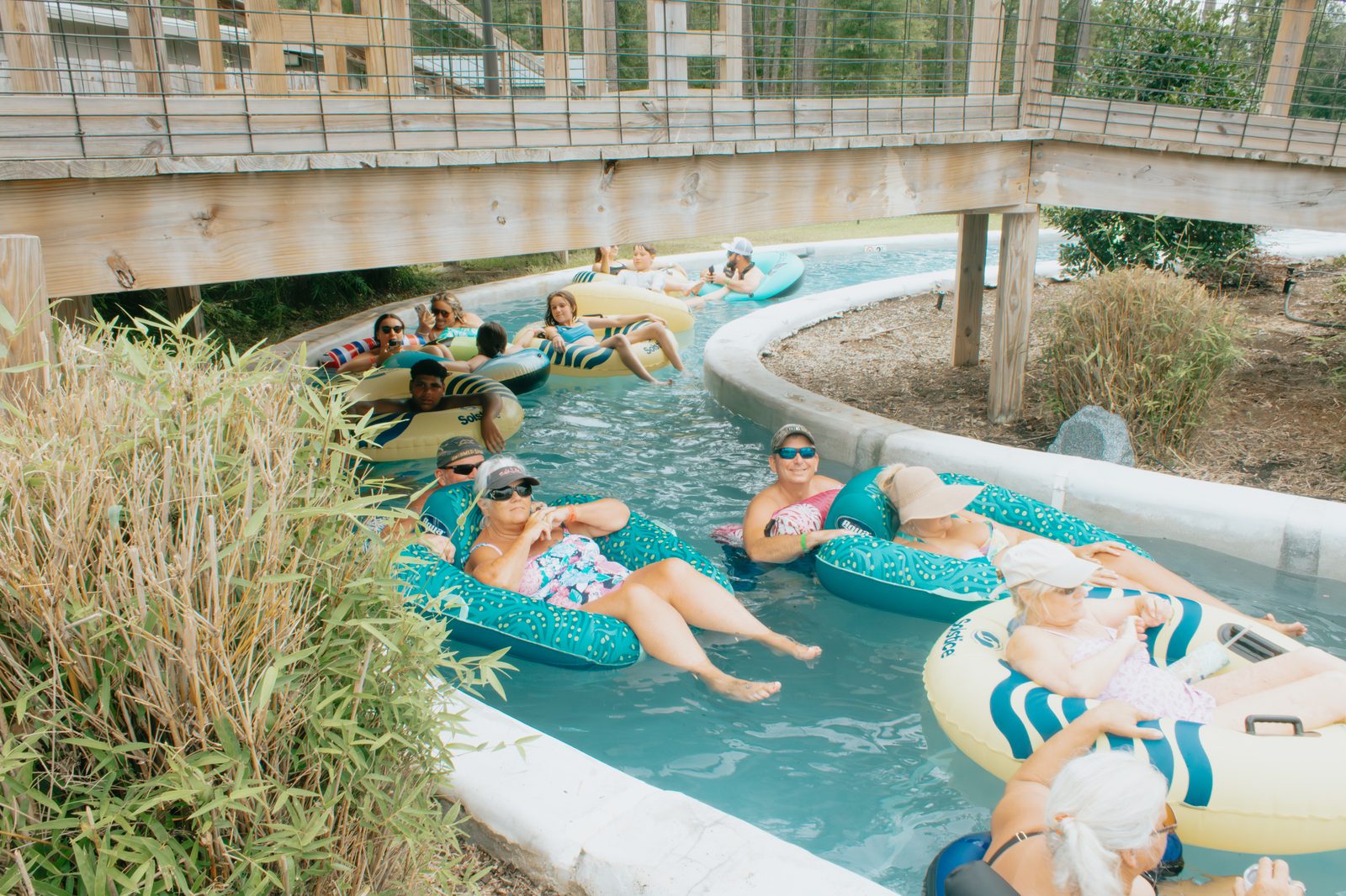 Guests floating on tubes down the year-round lazy river at Fireside RV Resort