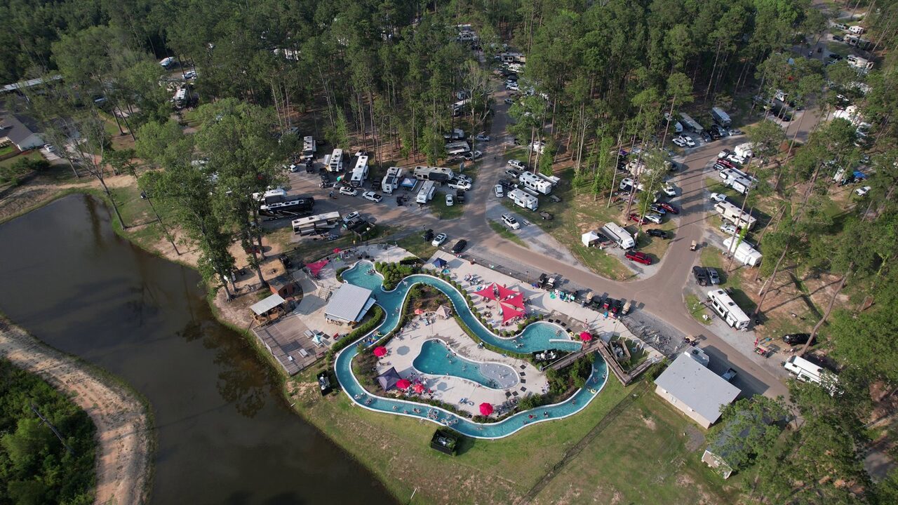 Aerial of the lazy river and two pools at a Northshore RV resort near New Orleans