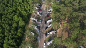 Aerial view of full hookup RV sites among pine trees at Fireside RV Resort, one of the best Gulf Coast RV parks, in Ponchatoula Louisiana