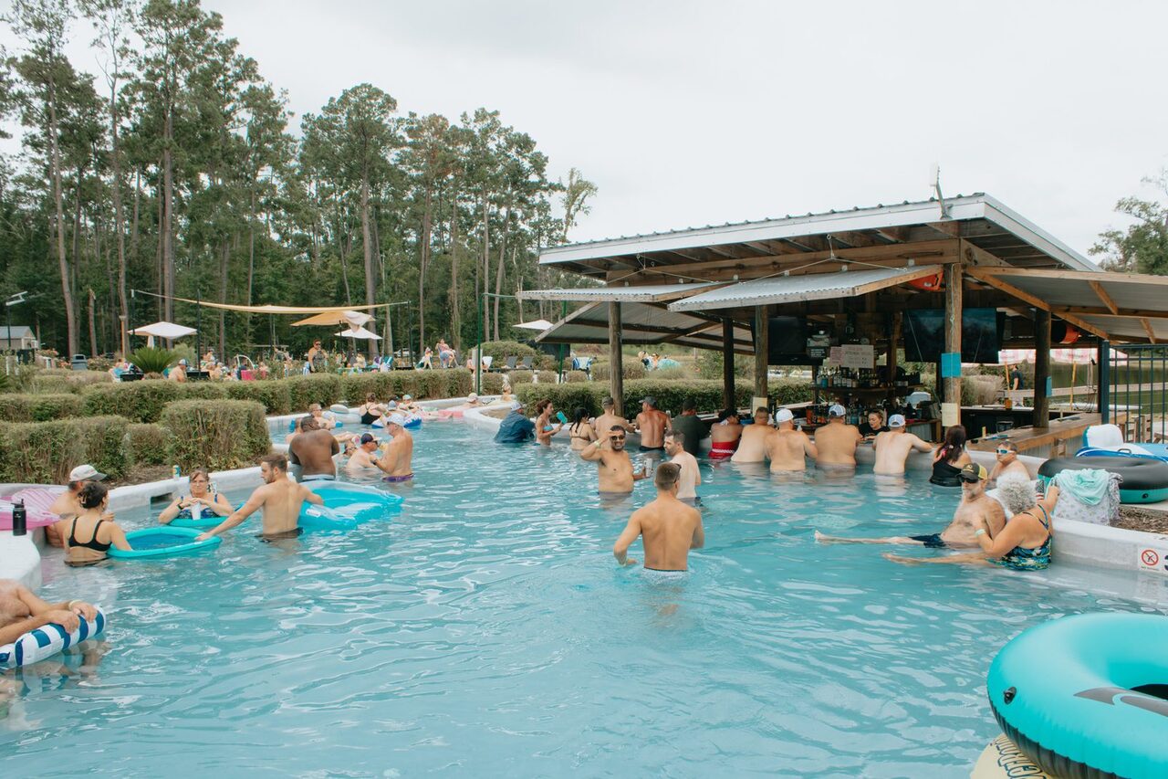 Guests enjoying the swim-up bar pool at Fireside RV Resort in Louisiana