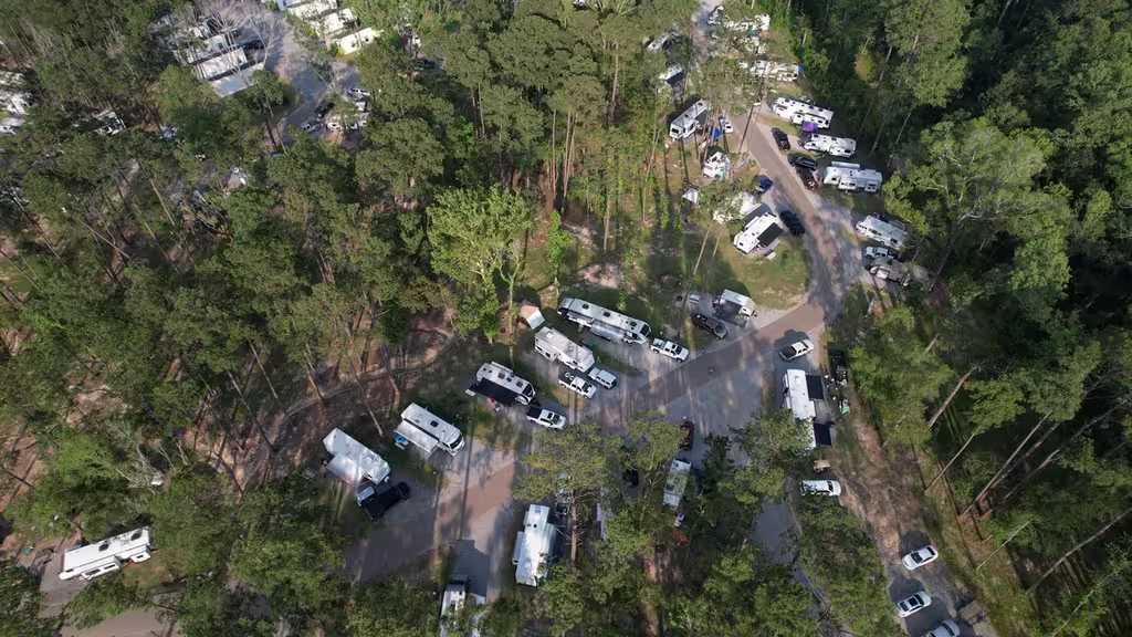 Aerial view of shaded RV sites among the pines at Fireside RV Resort near New Orleans