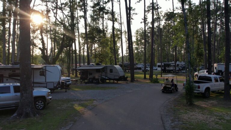 Full-hookup RV sites at dusk at Fireside RV Resort near New Orleans