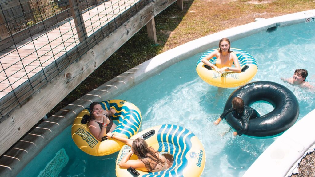 Guests floating the lazy river on yellow and blue tubes at Fireside RV Resort near Slidell LA