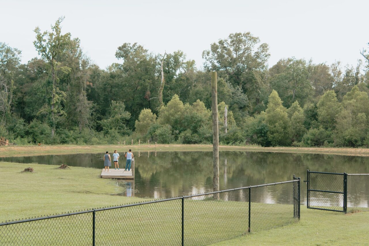 Guests on the dock at the fishing pond at Fireside RV Resort near New Orleans