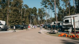 Fifth wheel RVs and pickup trucks lined up along a paved loop at a big rig friendly RV park in Ponchatoula, Louisiana