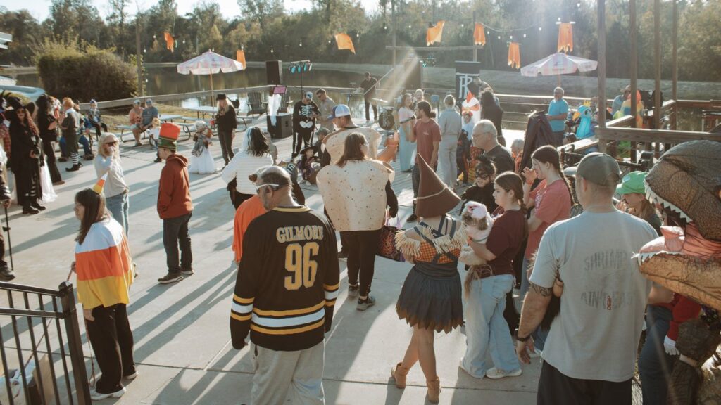 Guests in Halloween costumes on the lakeside deck at Fireside RV Resort, a short drive from Fontainebleau State Park LA