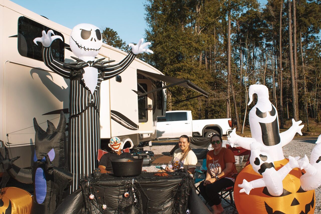 Guests relaxing among Halloween inflatables at a decorated RV site at Fireside RV Resort in Ponchatoula, Louisiana