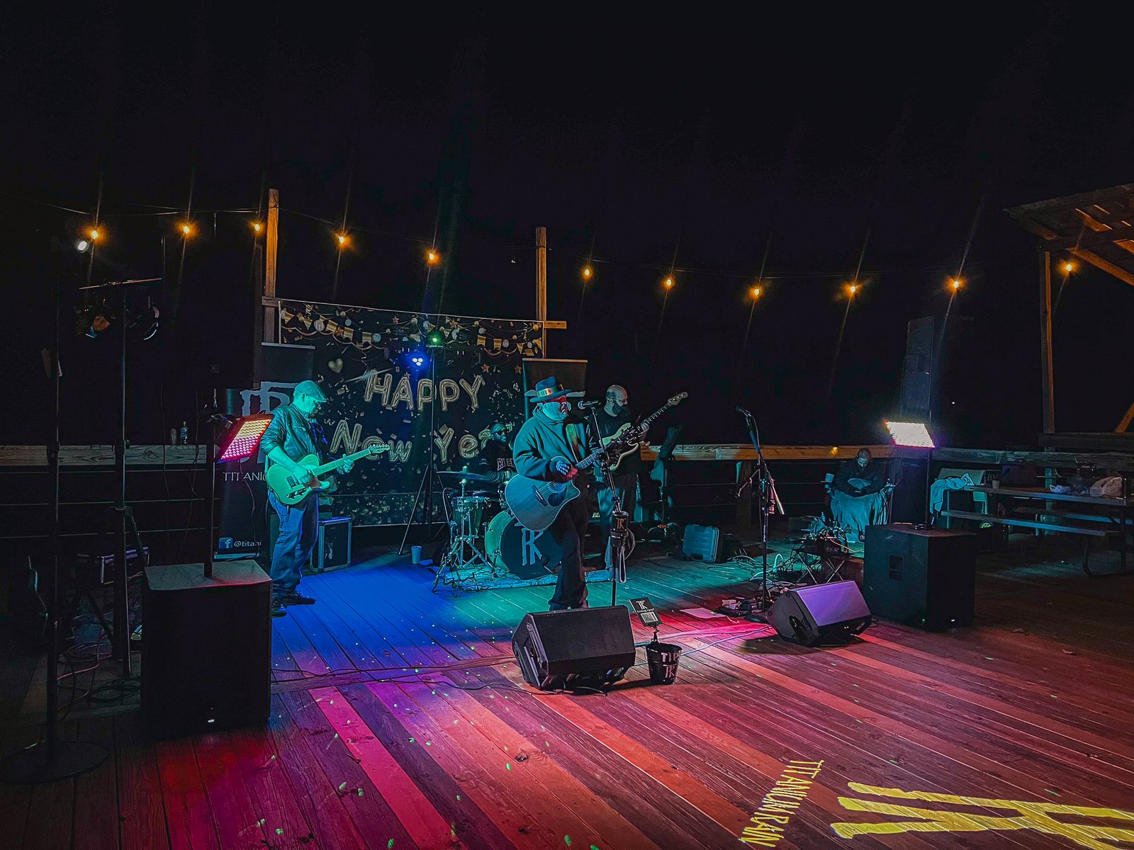 A live band plays under string lights on the outdoor stage at Fireside RV Resort on New Year's Eve